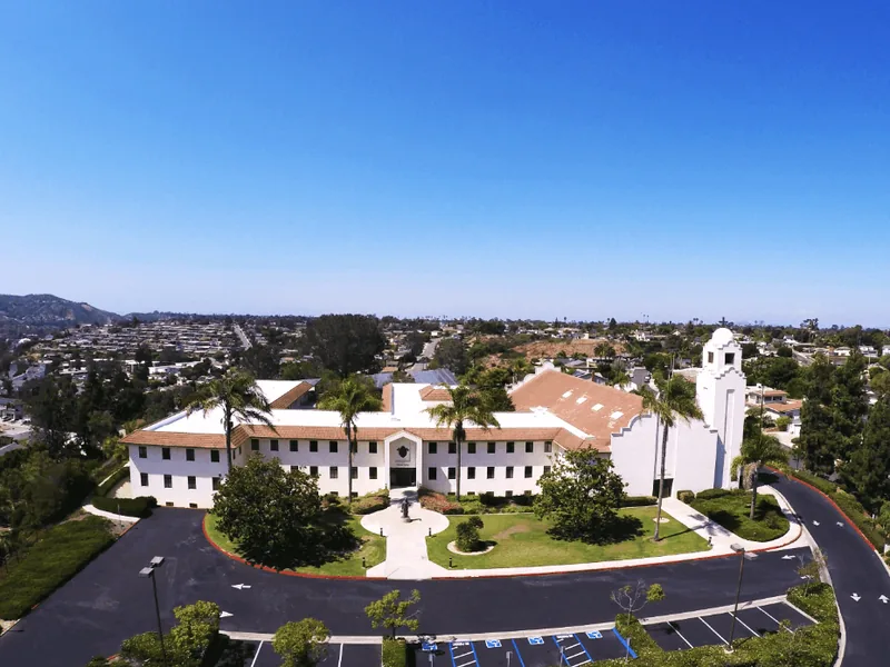 Aerial view of a Mission-style building and the surrounding Clairemont neighborhood in San Diego. water damage restoration Clairemont